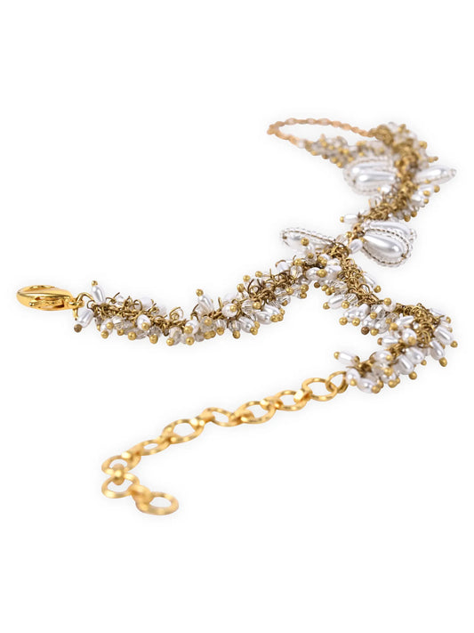 White pearl hand harness, beautifully designed to bring soft, graceful charm to your hands. Featuring delicate pearl detailing with a fine chain connecting the bracelet to the ring, this piece blends traditional beauty with modern sophistication.