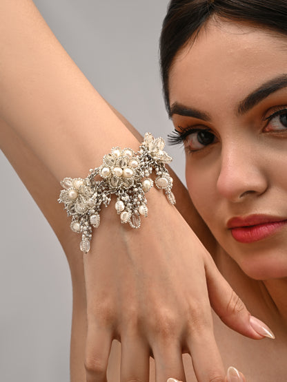 Handcrafted White & Silver Statement Bracelet with Intricate Hanging Charms, Pearl Beaded Detailing & Elegant Traditional Finish